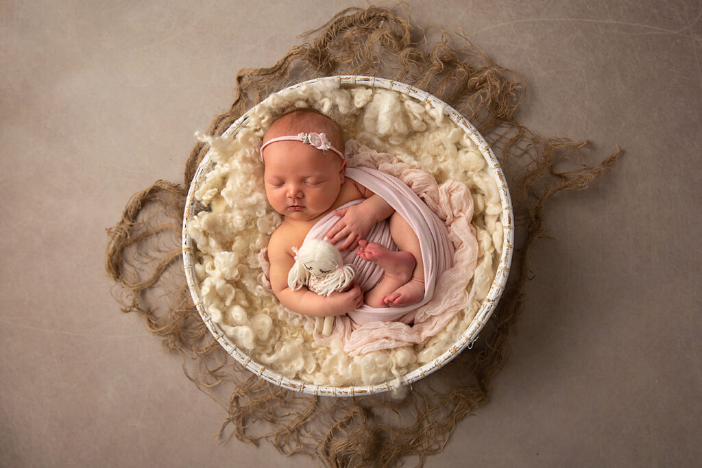 Brisbane Newborn photographer - wrapped newborn girl cuddle dolly