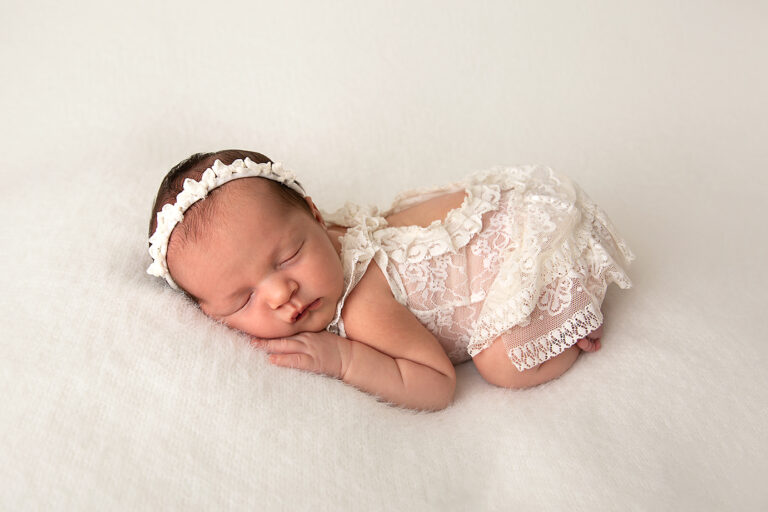 Brisbane newborn photographer - sleepy newborn wrapped in cream