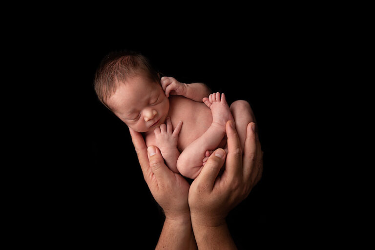 Tiny newborn hands held by parent - Brisbane newborn photography